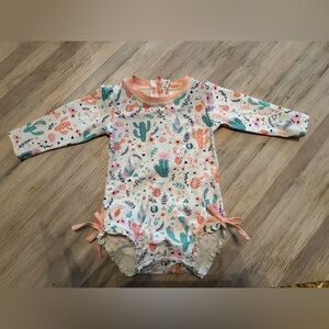 Ruffle Butts Swimsuit- Desert Cactus Print
Baby Girl size 6-12 months